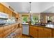 Bright kitchen with wood cabinets, modern appliances, and a view to the outdoors at 8007 Sunrise Cir, Frederick, CO 80516