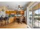 Open kitchen with a large granite island, breakfast bar, and a sliding glass door to a patio at 8007 Sunrise Cir, Frederick, CO 80516