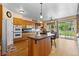 Bright, spacious kitchen with a large granite island, modern appliances, and wood cabinets at 8007 Sunrise Cir, Frederick, CO 80516