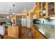 Spacious kitchen with granite counters, an island, hardwood floors, and stainless appliances at 8007 Sunrise Cir, Frederick, CO 80516