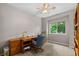 Bright home office featuring a wooden desk, chair, built-in storage, and a large window with natural light at 8007 Sunrise Cir, Frederick, CO 80516