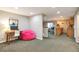 Finished basement with a desk area, pink beanbag chair, and open concept to the kitchenette at 10773 Cougar Rdg, Lone Tree, CO 80124