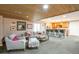 Open-concept basement with living and bar areas featuring wood ceilings and recessed lighting at 10773 Cougar Rdg, Lone Tree, CO 80124