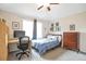 Bedroom with a bed, desk and chair, and large window providing natural light at 10773 Cougar Rdg, Lone Tree, CO 80124
