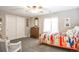 Cozy bedroom with gray carpet, bright, colorful quilt, a window and lots of closet space at 10773 Cougar Rdg, Lone Tree, CO 80124