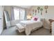 Light bedroom with decor, large window, bench seat, and neutral tones at 10773 Cougar Rdg, Lone Tree, CO 80124