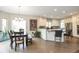 Inviting dining area features a modern chandelier, dining table, and seamless access to the kitchen at 10773 Cougar Rdg, Lone Tree, CO 80124