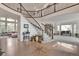 Expansive foyer features a hardwood floor with starburst design, winding staircase, and second-story balcony at 10773 Cougar Rdg, Lone Tree, CO 80124