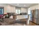 Modern kitchen features white cabinets, granite countertops, stainless steel appliances, and breakfast bar at 10773 Cougar Rdg, Lone Tree, CO 80124