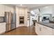 Spacious kitchen with a stainless steel refrigerator, built-in oven, and island seating at 10773 Cougar Rdg, Lone Tree, CO 80124
