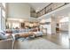 Open-concept living room provides ample space and natural light, seamlessly connecting to kitchen and dining areas at 10773 Cougar Rdg, Lone Tree, CO 80124