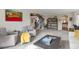Open living room with view of staircase, gray chairs, and large, open space at 10773 Cougar Rdg, Lone Tree, CO 80124