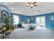 Spacious main bedroom with blue walls, vaulted ceilings, and lots of natural light at 10773 Cougar Rdg, Lone Tree, CO 80124
