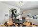 Charming dining area open to living space and kitchen, bathed in light at 1632 Ulster St, Denver, CO 80220