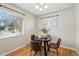 Inviting dining area with hardwood floors, a round table, and natural light at 1632 Ulster St, Denver, CO 80220