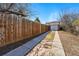 Long driveway to garage with privacy fence lining property at 1632 Ulster St, Denver, CO 80220