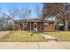Charming brick home featuring a well-maintained front yard and inviting entrance at 1632 Ulster St, Denver, CO 80220