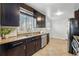 Modern kitchen with granite countertops, dark cabinets and stainless steel appliances at 1632 Ulster St, Denver, CO 80220