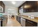 Well-appointed kitchen with stainless steel appliances, granite counters, and adjacent dining area, ideal for entertaining at 1632 Ulster St, Denver, CO 80220