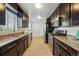 Modern kitchen featuring stainless steel appliances and granite countertops, offering a blend of style and functionality at 1632 Ulster St, Denver, CO 80220