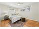 Bright bedroom with hardwood floors, large windows, and a cozy rug, creating a serene retreat at 1632 Ulster St, Denver, CO 80220