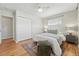 Comfortable bedroom features hardwood floors, a ceiling fan, and ample closet space for convenient storage at 1632 Ulster St, Denver, CO 80220