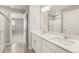 Bright bathroom features double sinks, vanity, and view to the bedroom at 17817 Dandy Brush Dr, Parker, CO 80134