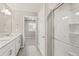 Bright bathroom with double sinks, vanity and glass-enclosed shower at 17817 Dandy Brush Dr, Parker, CO 80134