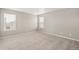Neutral bedroom showcasing plush carpeting and natural light from the windows at 17817 Dandy Brush Dr, Parker, CO 80134