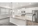 New kitchen features a granite island, stainless appliances, and wood flooring at 17817 Dandy Brush Dr, Parker, CO 80134
