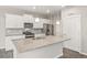 Bright kitchen features granite countertops, stainless steel appliances, and ample white cabinetry at 17817 Dandy Brush Dr, Parker, CO 80134