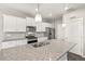 Bright kitchen features granite countertops, stainless steel appliances, and ample white cabinetry at 17817 Dandy Brush Dr, Parker, CO 80134