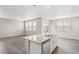 Open-concept living room area with wood floors that leads to the kitchen at 17817 Dandy Brush Dr, Parker, CO 80134