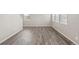 Spacious living room featuring gray wood flooring and neutral wall color at 17817 Dandy Brush Dr, Parker, CO 80134