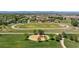 Aerial view of neighborhood with a playground, open fields and a school at 10570 Echo Ct, Firestone, CO 80504