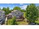 Aerial view of the home's exterior featuring a wood deck and mature trees at 10570 Echo Ct, Firestone, CO 80504