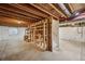 Unfinished basement with exposed ceiling, concrete floor and partially constructed shelving at 10570 Echo Ct, Firestone, CO 80504