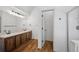 Bathroom boasts wood floors, double sink vanity, and glass-doored shower at 10570 Echo Ct, Firestone, CO 80504