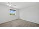 This bedroom has neutral carpet and a window offering exterior views at 10570 Echo Ct, Firestone, CO 80504