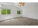 Bright, carpeted bedroom with large windows offering verdant views at 10570 Echo Ct, Firestone, CO 80504