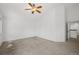 Neutral carpeted bedroom with a ceiling fan and large doorway at 10570 Echo Ct, Firestone, CO 80504