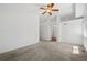 Carpeted bedroom features ceiling fan and an ensuite bathroom at 10570 Echo Ct, Firestone, CO 80504