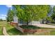 Charming two-story home with a wooden retaining wall and mature landscaping on a sunny day at 10570 Echo Ct, Firestone, CO 80504