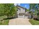 Charming two-story home with a three-car garage and mature landscaping on a sunny day at 10570 Echo Ct, Firestone, CO 80504