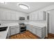 Modern kitchen with stainless steel appliances, sleek grey cabinets, and beautiful marble countertops at 10570 Echo Ct, Firestone, CO 80504