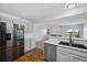 Bright kitchen with stainless steel appliances, marble countertops, and convenient access to the living area at 10570 Echo Ct, Firestone, CO 80504