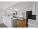 Well-lit kitchen featuring white cabinets, stainless steel appliances, and marble countertops at 10570 Echo Ct, Firestone, CO 80504