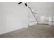 Bright, open living room with neutral carpet and staircase, providing a comfortable living space at 10570 Echo Ct, Firestone, CO 80504