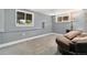 Cozy room with neutral walls and carpet, featuring a comfortable seating area and natural light from windows at 3390 S Ensenada Way, Aurora, CO 80013