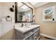 Bright bathroom features double sink vanity, updated fixtures, and plenty of natural light from the window at 3390 S Ensenada Way, Aurora, CO 80013
